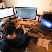 A computer scientist works in his home office  (Ina Fassbender/AFP via Getty Images)