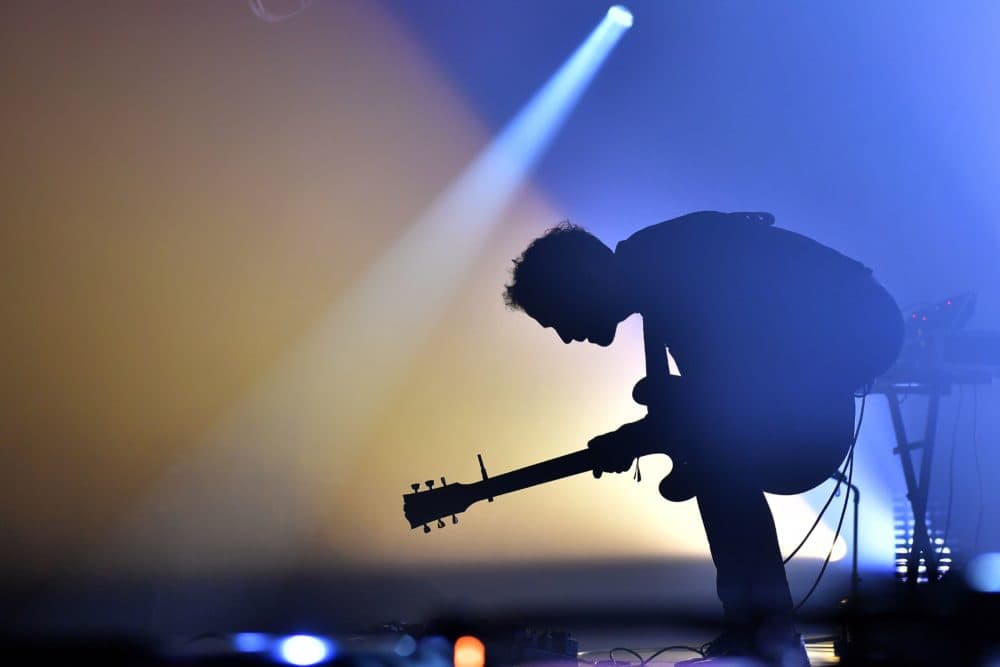 A guitarist preforms. (Loic Venance/AFP via Getty Images)