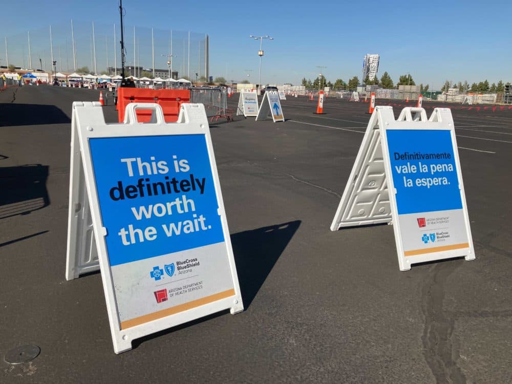 Signs outside of Arizona Cardinal's stadium vaccination site. (Peter O'Dowd/Here & Now)