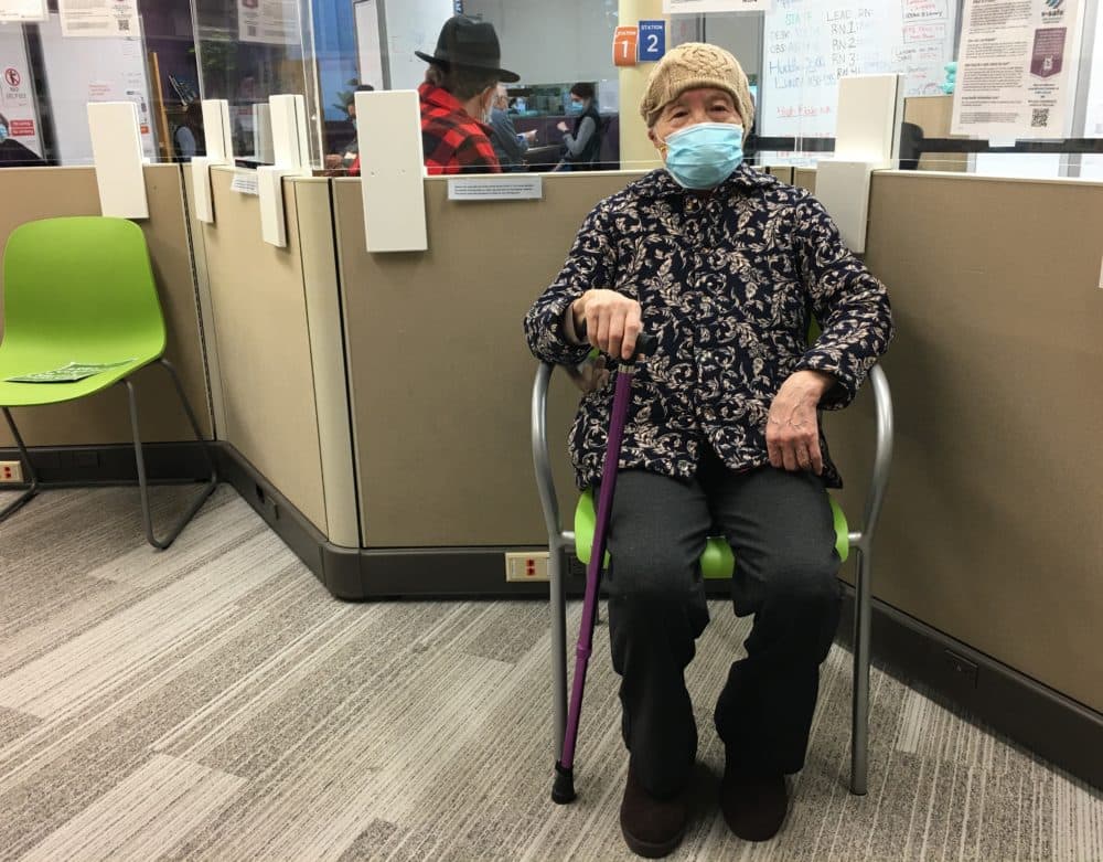 Mei Liu rests after receiving her first dose of the COVID-19 vaccine at a Seattle Children’s Hospital vaccine clinic on Feb. 10. Liu had tried and failed to secure an appointment. It took multiple helpers days to finally find an open spot for her. (Deborah Wang)