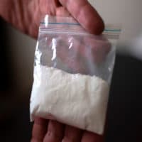 A cocaine consumer shows a bag of the drug. (Juan Manuel Barrero/AFP/Getty Images)