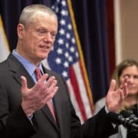 Gov. Charlie Baker talks with reporters at a press conference in the State House in March 2020. (Robin Lubbock/WBUR)
