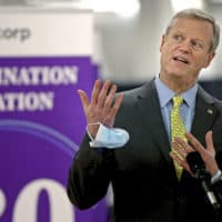 Massachusetts Gov. Charlie Baker speaks at a vaccination site at the Natick Mall on Feb. 24. A year of battling the spread of the coronavirus has taken a political toll on Baker as he faces slumping popularity. (Matt Stone/Boston Herald via AP, Pool, File)