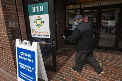 A man enters the La Colaborativa offices on Broadway which is serving as the Chelsea public COVID-19 vaccination site. (Jesse Costa/WBUR)