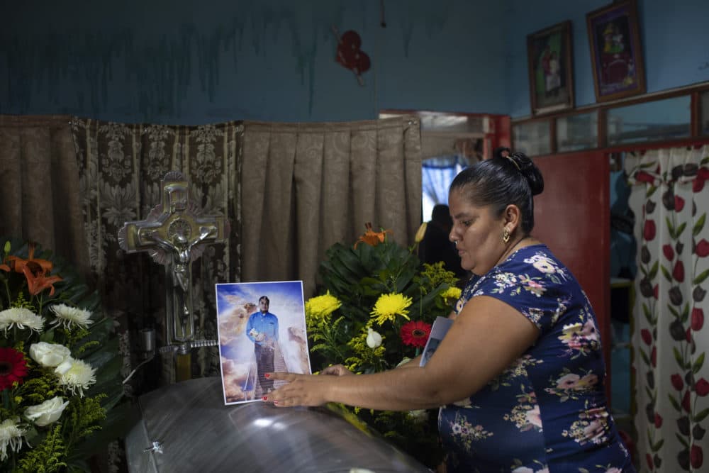 A woman places a photo of slain journalist Julio Valdivia on his casket during a wake for him inside his home in Tezonapa, Mexico, on Sept. 10, 2020. Valdivia's decapitated body was found five miles from Tezonapa a day earlier, and is at least the third reporter killed in the area since 2015. (Felix Marquez/AP)