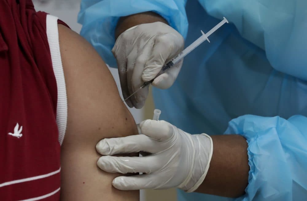 A health worker gets a second shot of the Pfizer-BioNTech vaccine for COVID-19 at Santo Tomas Hospital in Panama City. (Arnulfo Franco/AP)