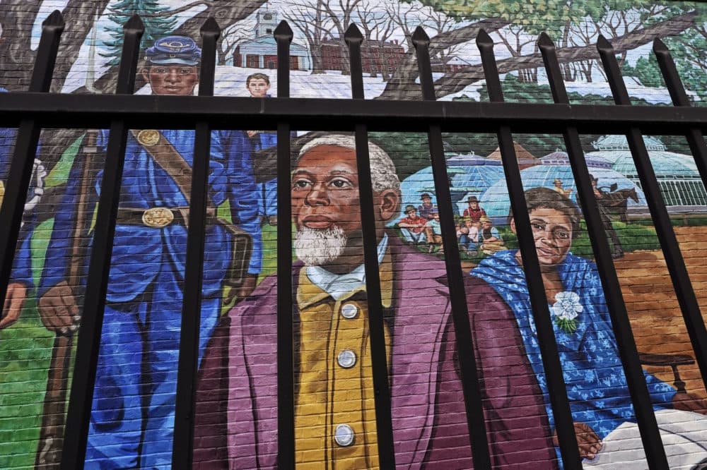 Past Amherst, Mass., area residents Henry Jackson, center, Lt. Frazar Stearns, left, and Anna Reed Goodwin, right, are featured on the Amherst Community History Mural, as seen through the adjacent West Cemetery fence. (Charles Krupa/AP)