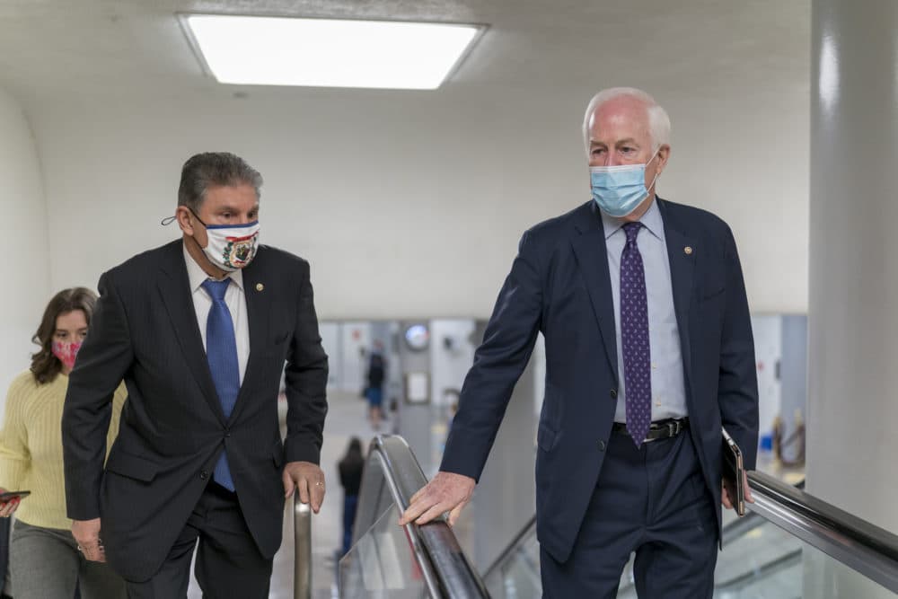 Sen. Joe Manchin, D-W.Va., left, and Sen. John Cornyn, R-Texas, head to the chamber as the Senate steers toward a voting marathon on the Democrats' $1.9 trillion COVID-19 relief bill. (J. Scott Applewhite/AP)