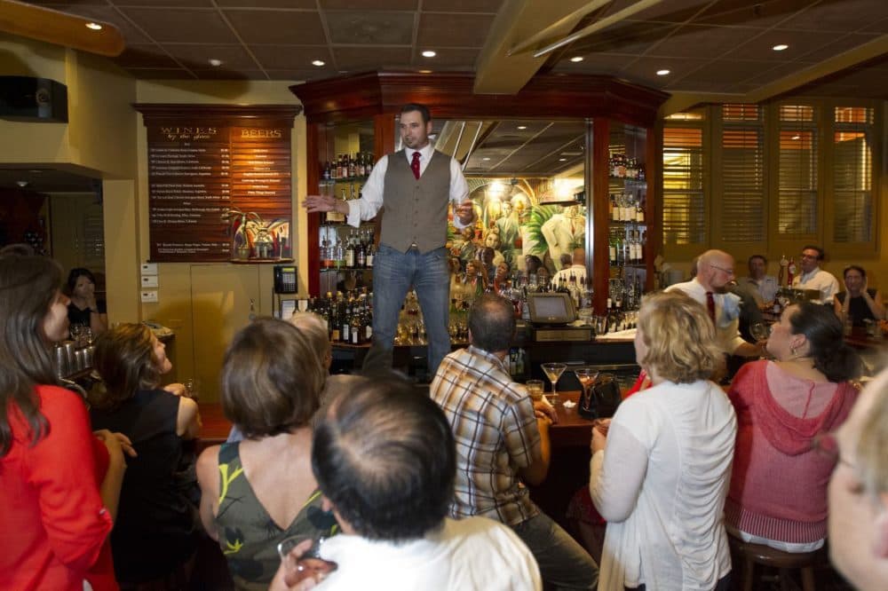Jason Abul-Jubein, son of Casablanca owner, Sari, making a farewell toast at the restaurant in 2012, the year it closed. (Courtesy Boston Globe/Matthew J. Lee)