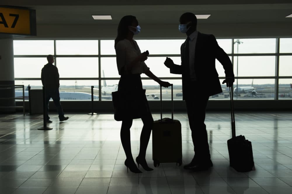 People talking inside of an airport. (Getty Images)