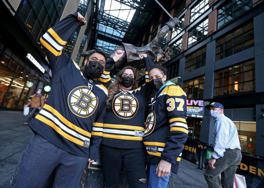 Bruins fans Luis Calderon, Kelsey Belair and Kiana Delgado of Leominster get ready for the NHL game against New York Islanders at the TD Garden on March 25, 2021 in Boston. (Matt Stone/MediaNews Group/Boston Herald via Getty Images)