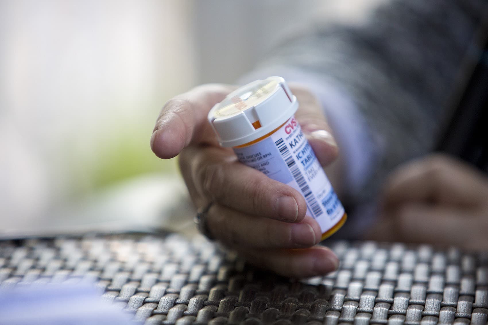 Katie Herzog holds a prescription bottle of the remaining tablets of Dilaudid. (Jesse Costa/WBUR)