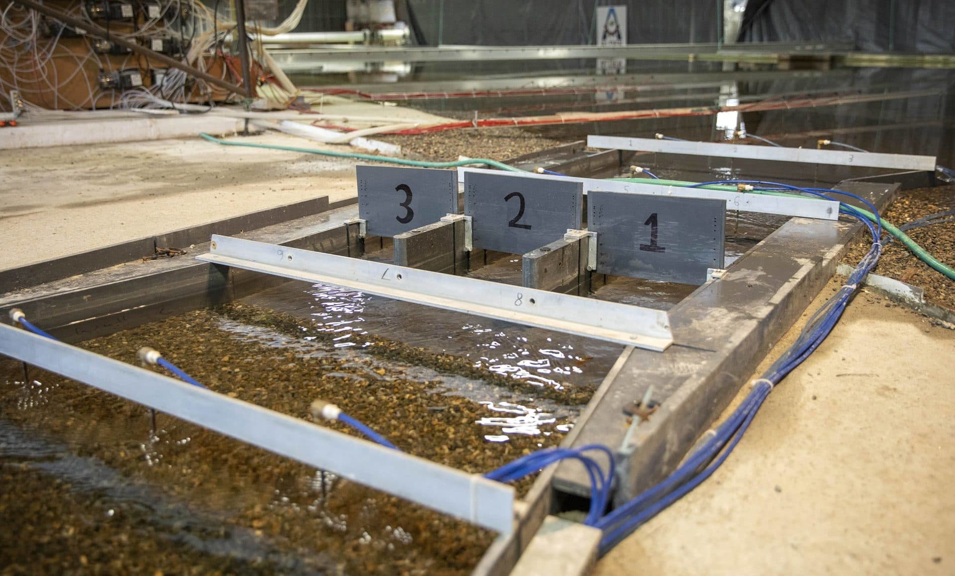 The sediment diversion structure and bulkhead gates that, when built full scale on the Mississippi River, will allow sediment laden water to travel down a channel towards Barataria Bay. (Robin Lubbock/WBUR)