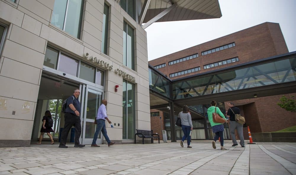 Students and faculty walk out of the Campus Center at UMass Boston. (Jesse Costa/WBUR)