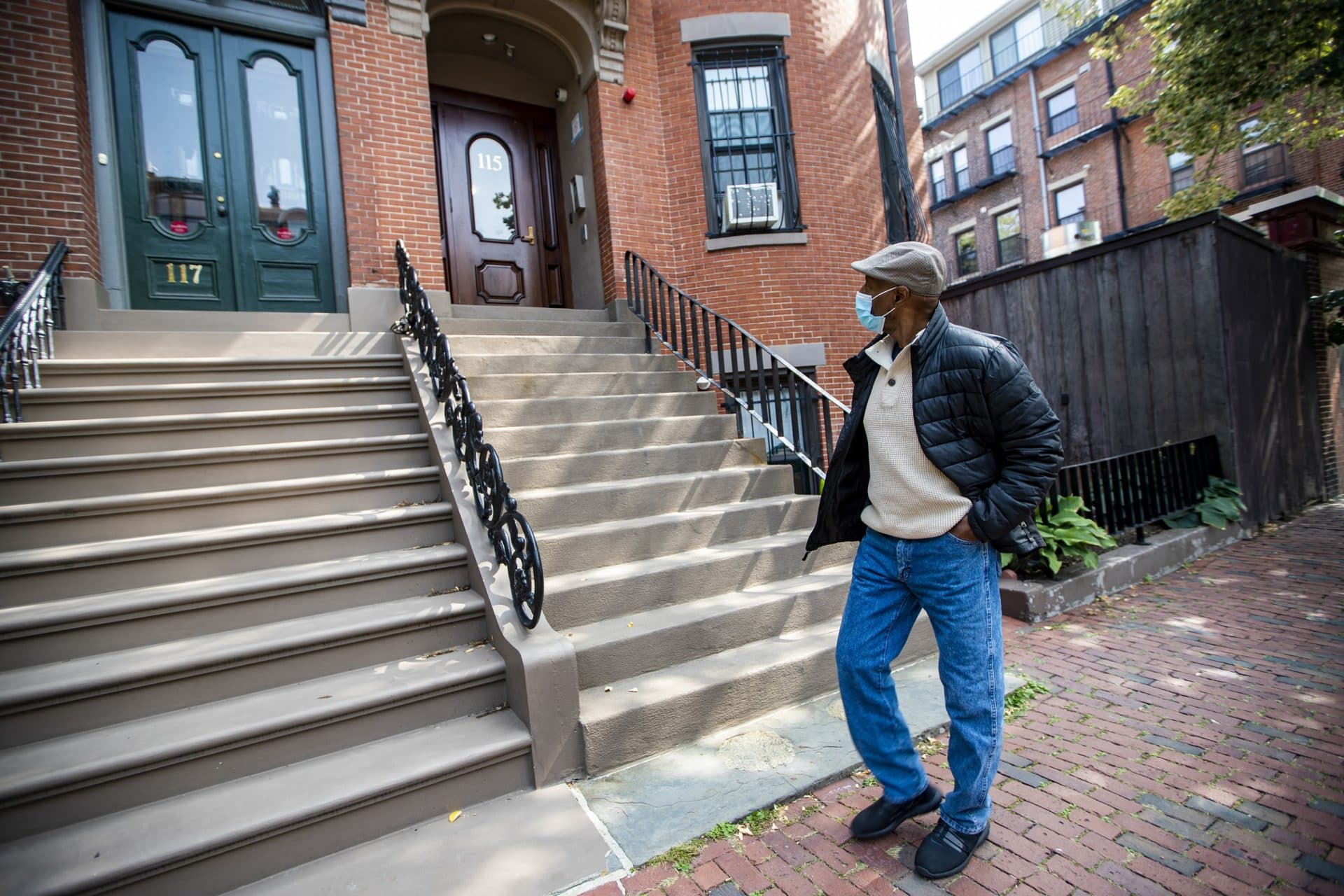 Charles Clark, of Tenants’ Development Corp., walks past an apartment in the South End, one of the affordable housing properties managed by the nonprofit. (Jesse Costa/WBUR)