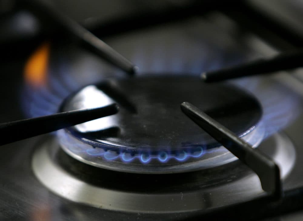 A gas lit flame burns on a natural gas stove.  (Thomas Kienzle/AP)