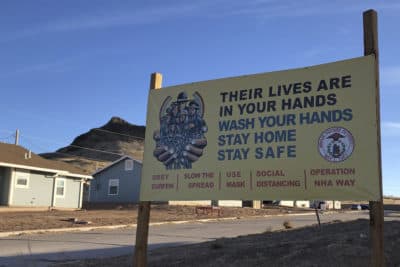 A sign urging safety measures during the  pandemic is seen in Teesto, Arizona, on the Navajo Nation on Feb. 11, 2021. (Felicia Fonseca/AP)