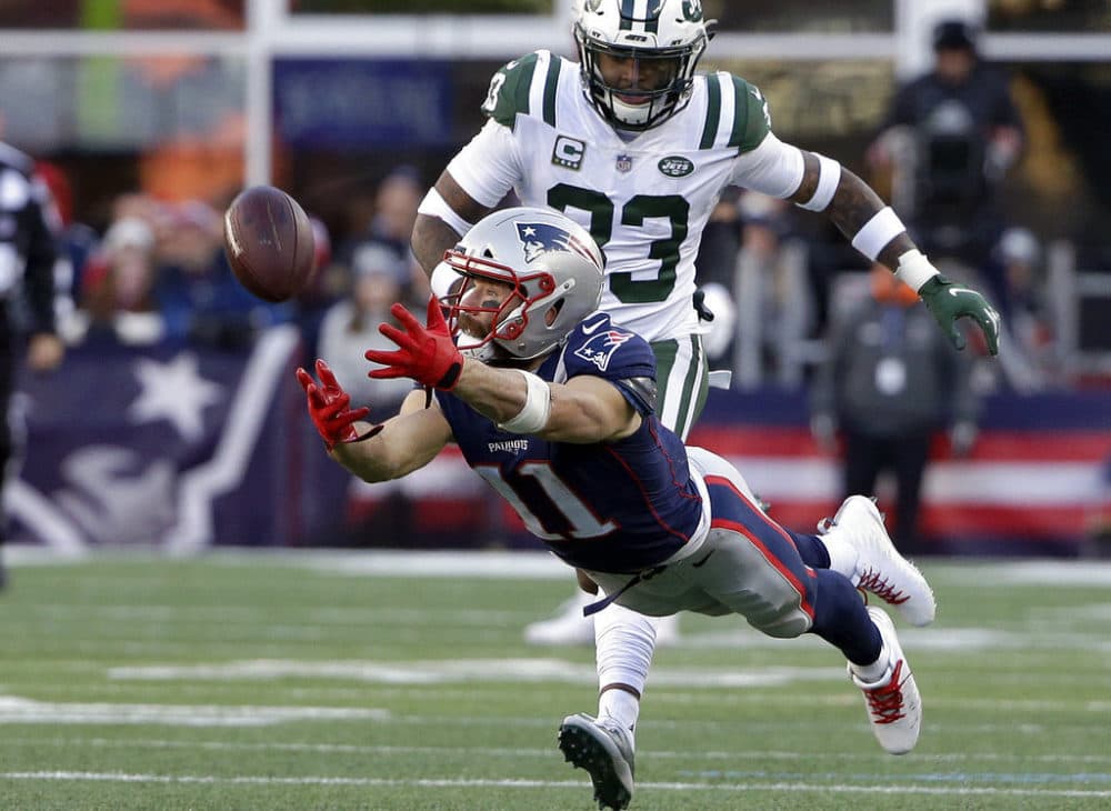 New England Patriots wide receiver Julian Edelman (11) stretches but cannot catch a pass in front of New York Jets safety Jamal Adams in 2018. (Steven Senne/AP)