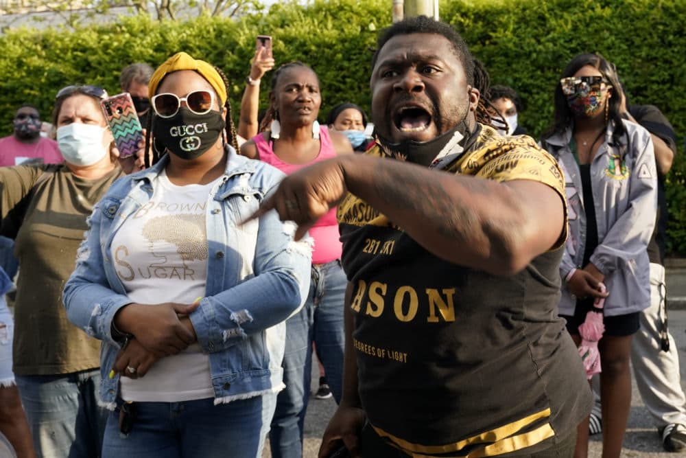 People gather outside the municipal building after at least one Pasquotank County Sheriff's deputy shot and killed a Black man while executing a search warrant, the sheriff's office said, April 21, 2021, in Elizabeth City, N.C. (Gerry Broome/AP)