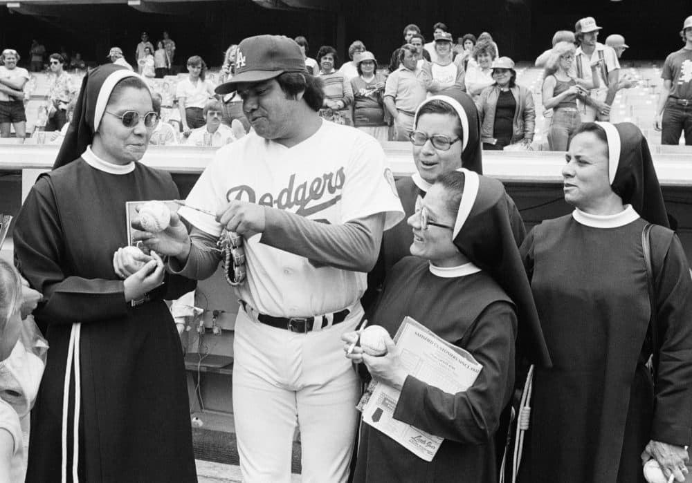 Los Angeles Dodgers rookie pitching sensation Fernando Valenzuela autographs baseballs for a group of teachers from St. Joseph's Catholic School in Placentisa Cal. on May 31, 1981 before game against the Cincinnati Reds in Los Angles. (Ramussen/AP)