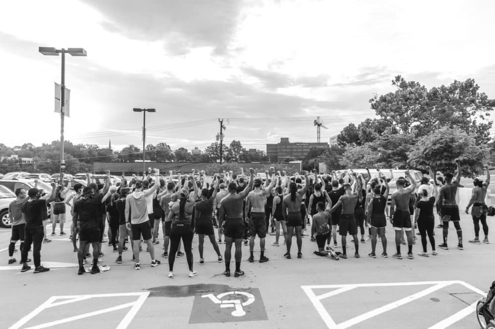 Prolyfyck Run Crew raise their arms following a run honoring Jacob Blake, who was paralyzed in a police shooting in Kenosha, WI. (Derrick J. Waller)