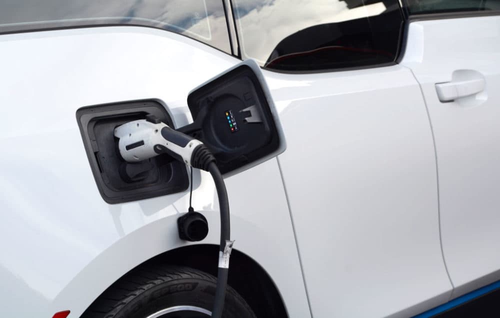 An electric BMW vehicle gets its batteries charged in the parking lot of a hotel in San Francisco, California. (Robert Alexander/Getty Images)