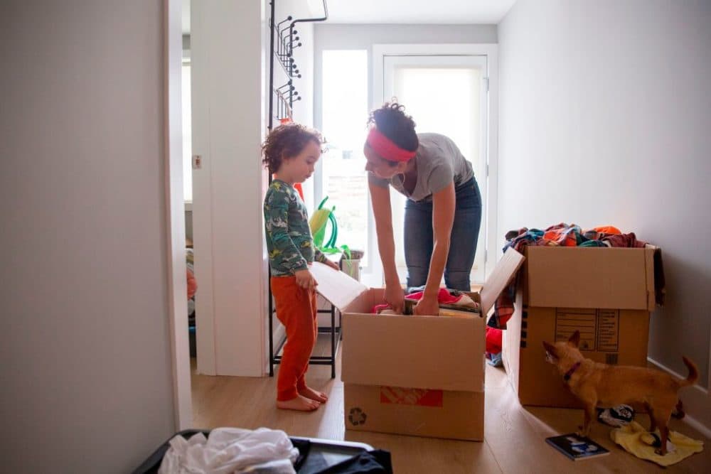 Levi Benjamin-Brown, 5, helps him mother Kyala Brown unpack does of toys at their new home in El Cerrito, California on September 11, 2020. . (Brittany Hosea-Small/AFP via Getty Images)