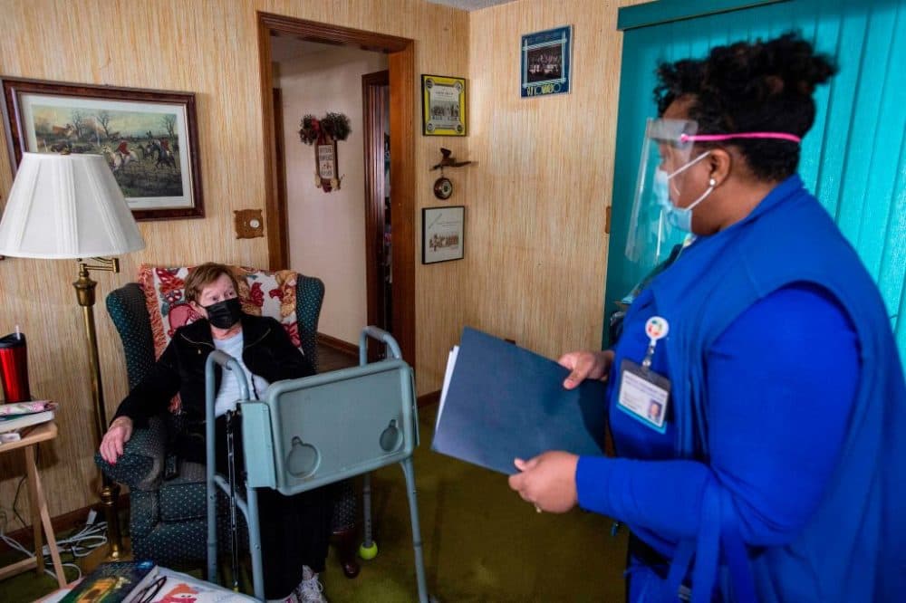R.N Natalie O'Connor greets her first patient of the day Rita Fuller, 83, at her home and goes over a COVID-19 pre-vaccine checklist before administering it in Manchester, Connecticut on February 12, 2021. (Photo by Joseph Prezioso/AFP via Getty Images)