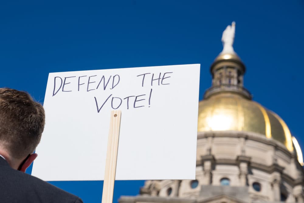 Demonstrators stand outside of the Capitol building in opposition of House Bill 531 on March 8, 2021 in Atlanta, Georgia. HB531 will restrict early voting hours, remove drop boxes, and require the use of a government ID when voting by mail.  (Megan Varner/Getty Images)