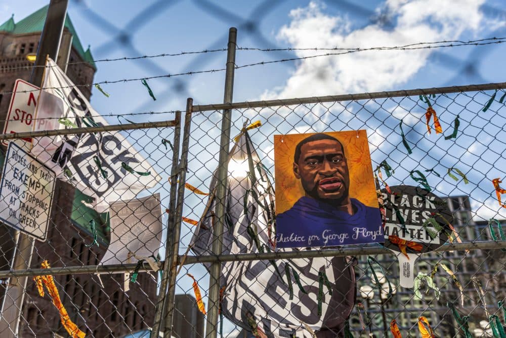 A poster with George Floyd's picture and a sign reads that "I Can't Breathe" hang from a security fence outside the Hennepin County Government Center on March 31, 2021 in Minneapolis, Minnesota. (Kerem Yucel/AFP via Getty Images)