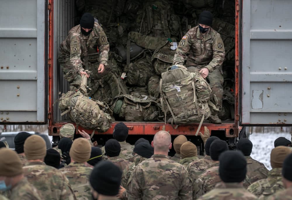 U.S. Army soldiers retrieve their duffel bags after they returned home from a 9-month deployment to Afghanistan on December 10, 2020 at Fort Drum, New York. (John Moore/Getty Images)