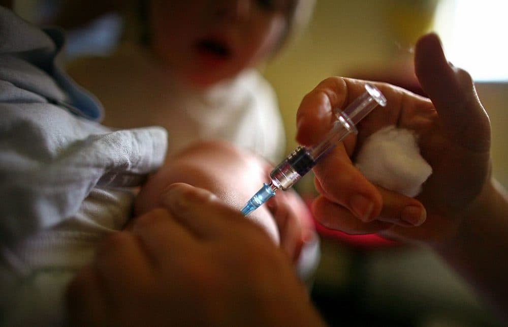 A young boy receives a MMR immunization jab at a health center in Glasgow on Sept. 3, 2007 in Glasgow, Scotland. (Jeff J Mitchell/Getty Images)