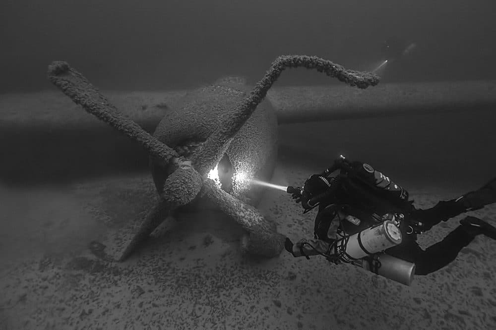 A National Park Service Submerged Resources Center diver assesses the B-29 in 2013. (Brett Seymour/NPS Submerged Resources Center)