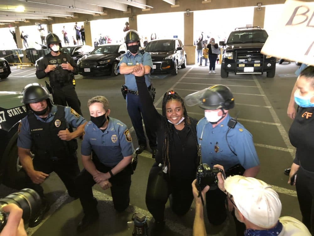 Northampton, Massachusetts, Police Chief Jody Kasper, kneeling second from left, with protesters last summer. (Alden Bourne / NEPR)