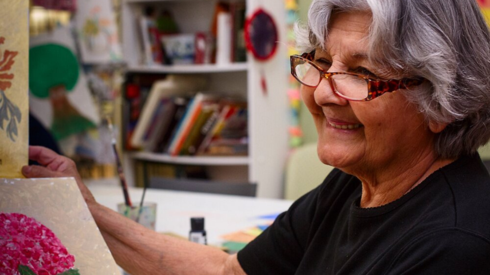Darcy De Souza with pieces of her artwork (Courtesy Women's Lunch Place)
