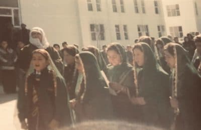 Zarifa Hamidi, center with white paper, in the early 2000s at an orphanage in Afghanistan. (Courtesy)