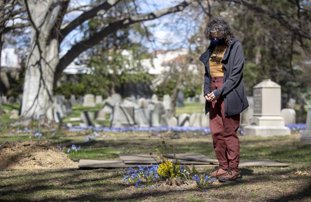 Mishy Lesser stands at the green burial site of her mother, Nettie Lesser. (Robin Lubbock/WBUR)