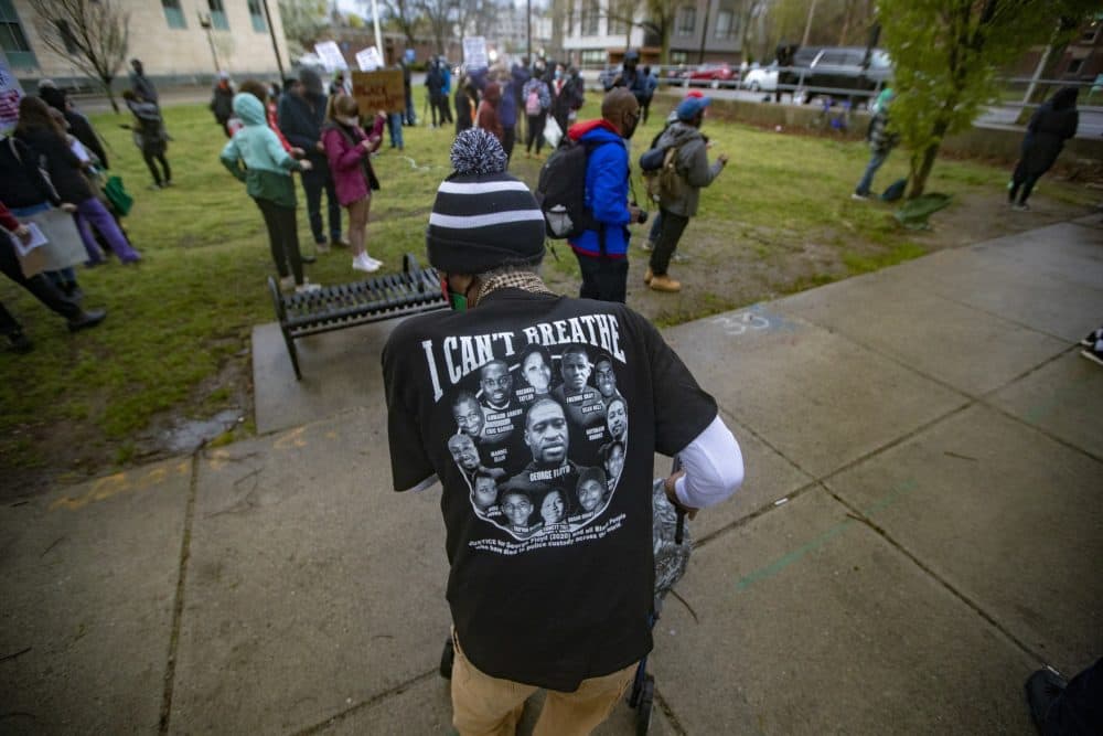 Mr. Marshall Cooper wears a a T-shirt that reads “I CAN’T BREATHE” with the names and faces of those killed by police at a rally. (Jesse Costa/WBUR)