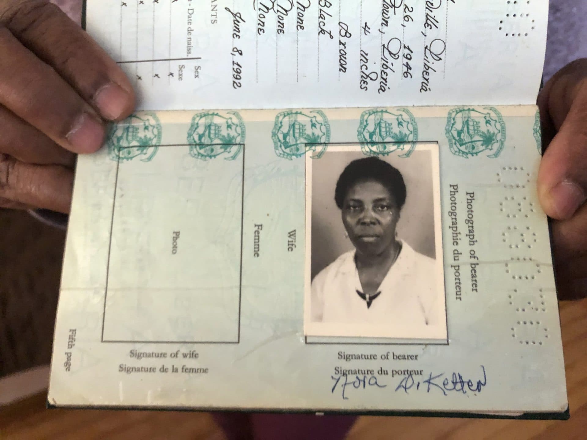 Nora Ketter's Liberian passport. She came to the U.S. in 1989 on a visitor visa. (Lynn Jolicoeur/WBUR)