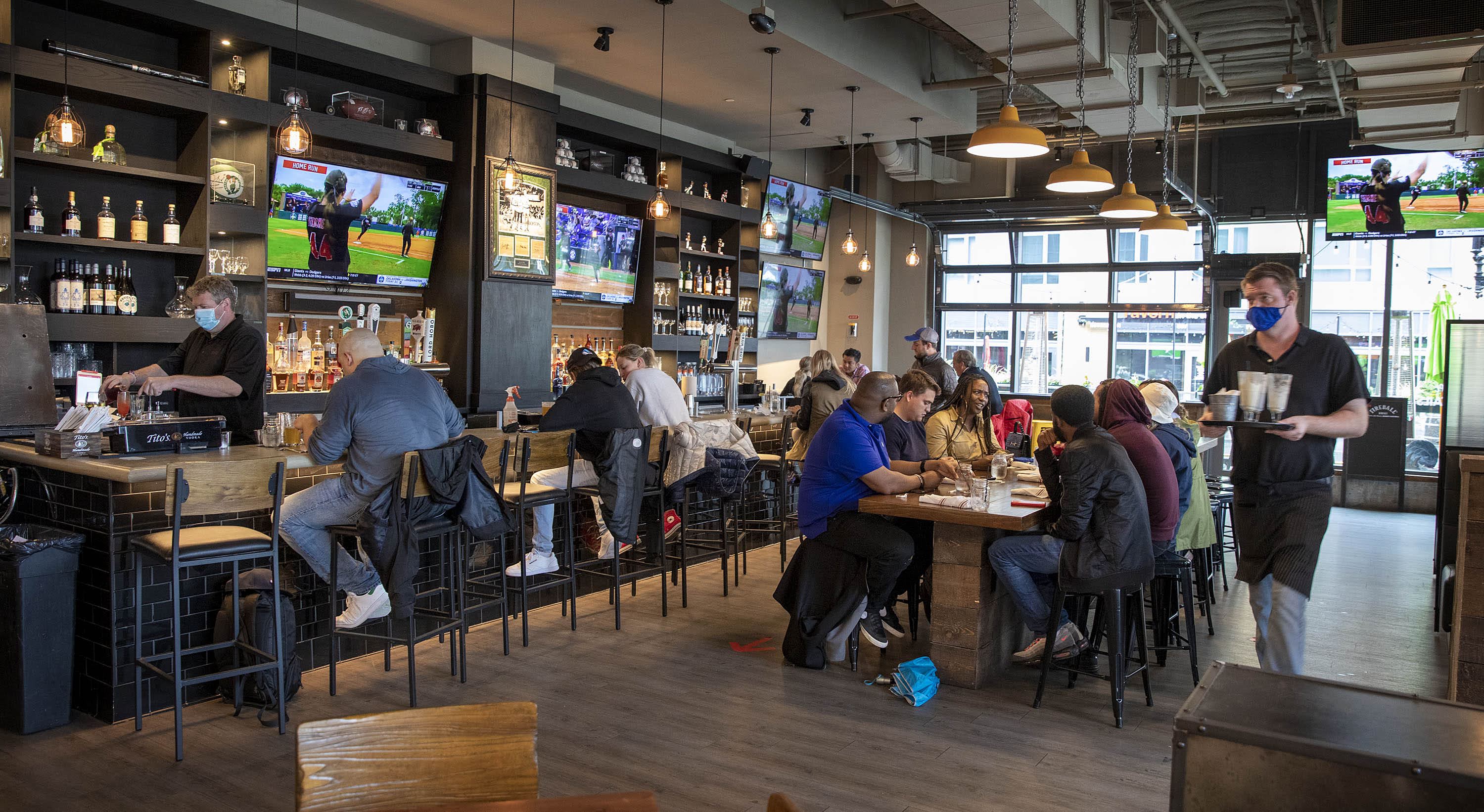Customers gather at the A&B Kitchen • Bar in Boston on Saturday, the first day that the majority of pandemic restrictions are lifted on businesses in Massachusetts. (Robin Lubbock/WBUR)
