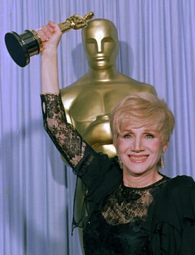In this April 11, 1988 photo, Olympia Dukakis holds her Oscar at the Shrine Auditorium in Los Angles after being honored at the 60th Academy Awards as best supporting actress for her role in "Moonstruck."(Lennox Mcleondon/AP)