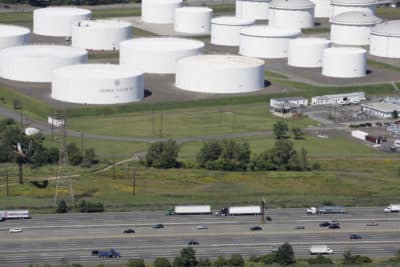 Traffic on I-95 passes oil storage tanks owned by the Colonial Pipeline Company in Linden, N.J. on Sept. 8, 2008. A major pipeline that transports fuels along the East Coast says it had to stop operations because it was the victim of a cyberattack. (Mark Lennihan/AP)