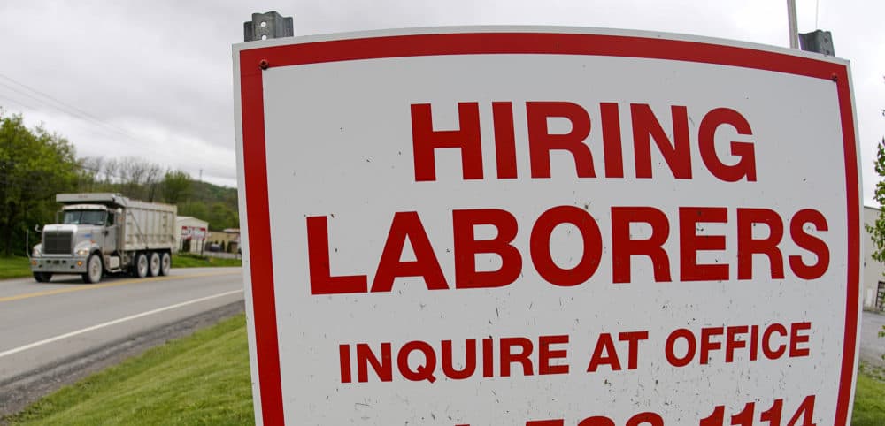 On May 5, 2021, a truck passes a sign showing a need to hire laborers outside a concrete products company in Evans City, Pa. (Keith Srakocic/AP File)