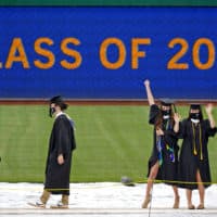 University of Pittsburgh candidates for graduation line up to receive their diplomas during the graduation ceremony for the Kenneth P. Dietrich School of Arts and Sciences and the School of General Studies at PNC Park in Pittsburgh, May 4, 2021.(Gene J. Puskar/AP)