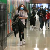 Freshman students walk the hallway in between classes during the bell break, which normally would be packed by students, at Brockton High School in Brockton, Mass. on March 2, 2021. (David L. Ryan/The Boston Globe via Getty Images)