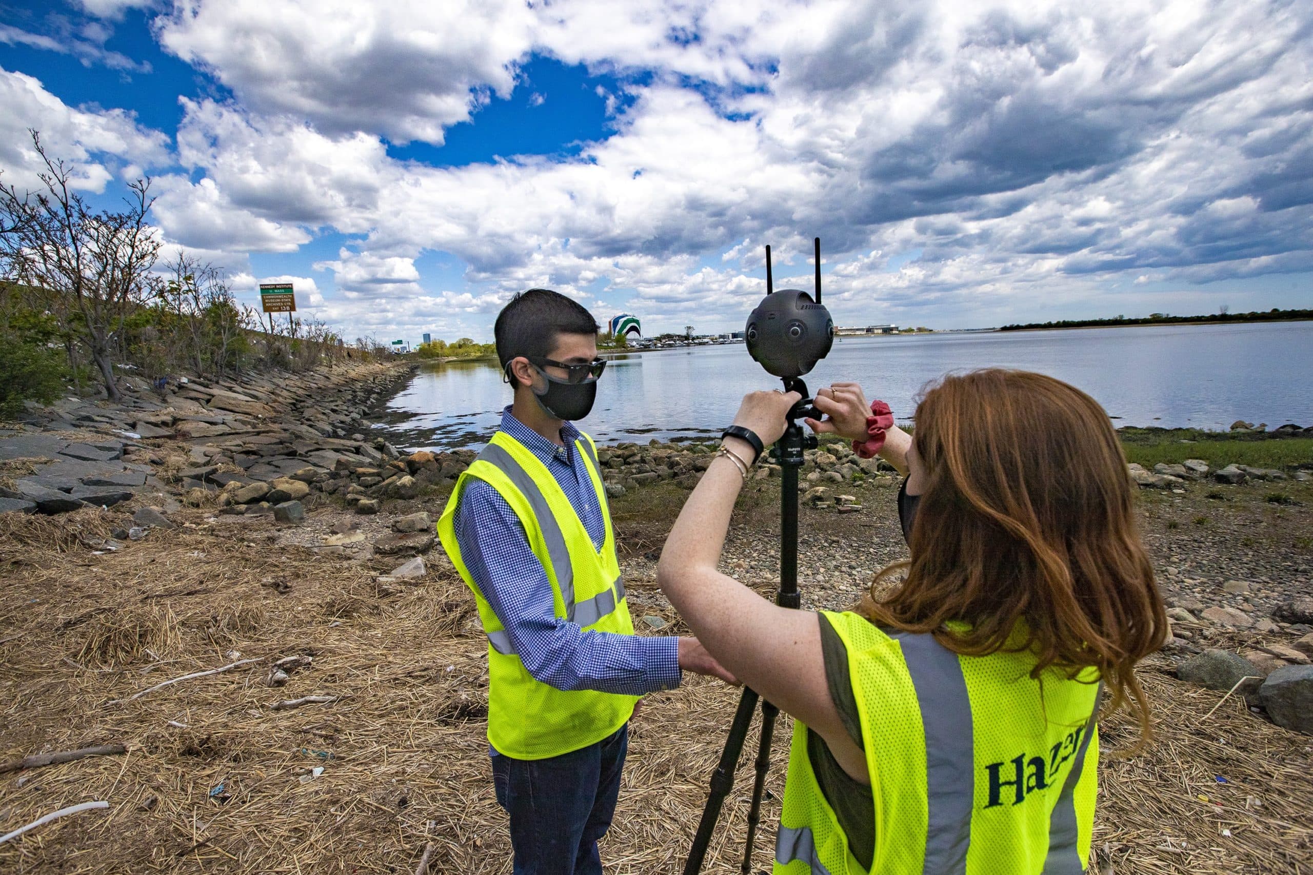 Engineers Ben Agrawal and Madison Gleason set up a 360 camera to survey the area along the Neponset River by Tenean Beach in Dorchester. (Jesse Costa/WBUR)