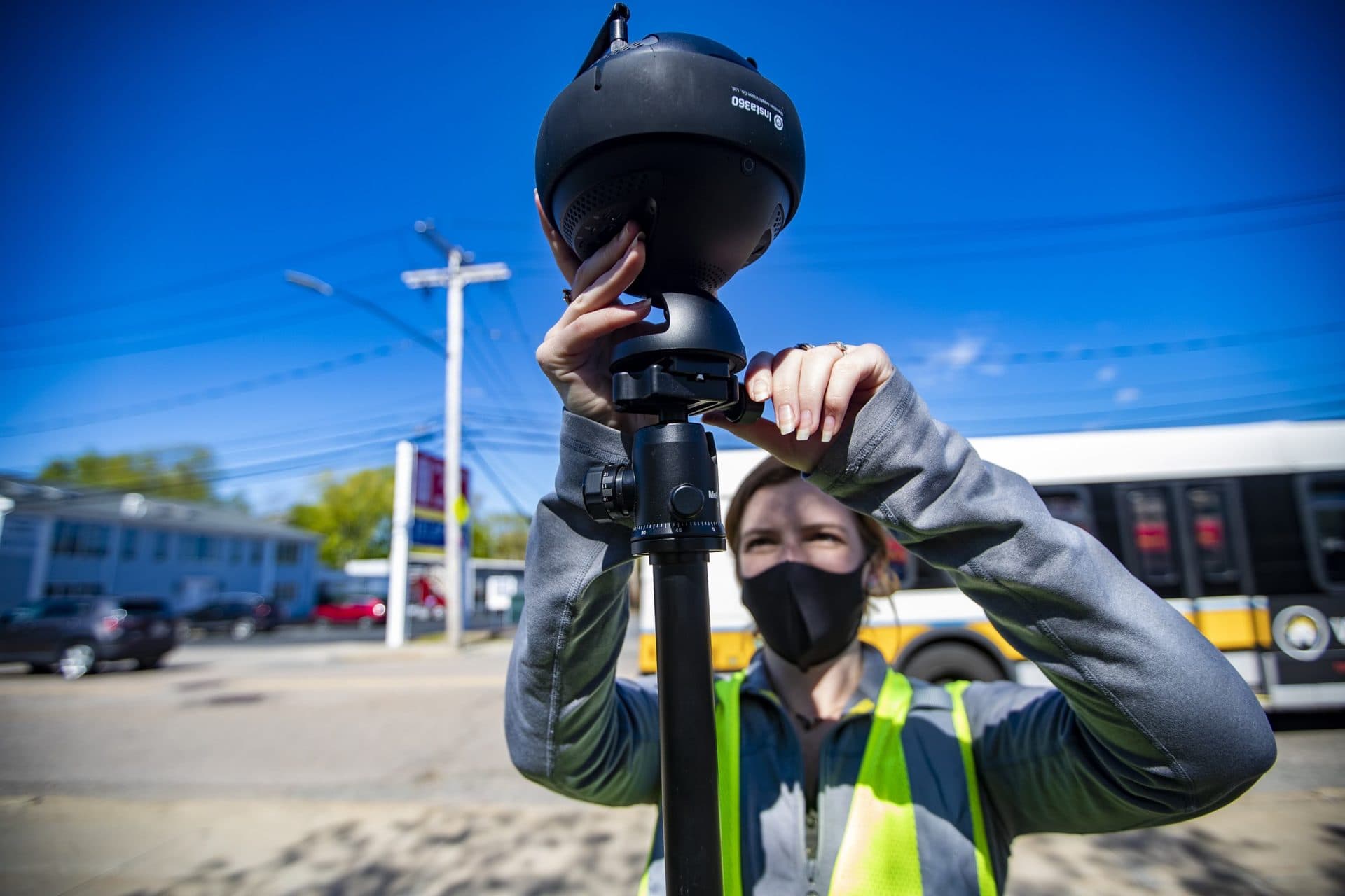 Engineer Madison Gleason sets up a 360 camera to survey the area around Hallet Street in Dorchester. (Jesse Costa/WBUR)