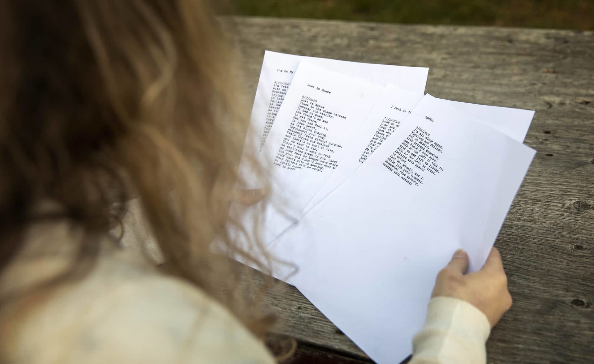 Marie looks through some of her typed poems. (Robin Lubbock/WBUR)