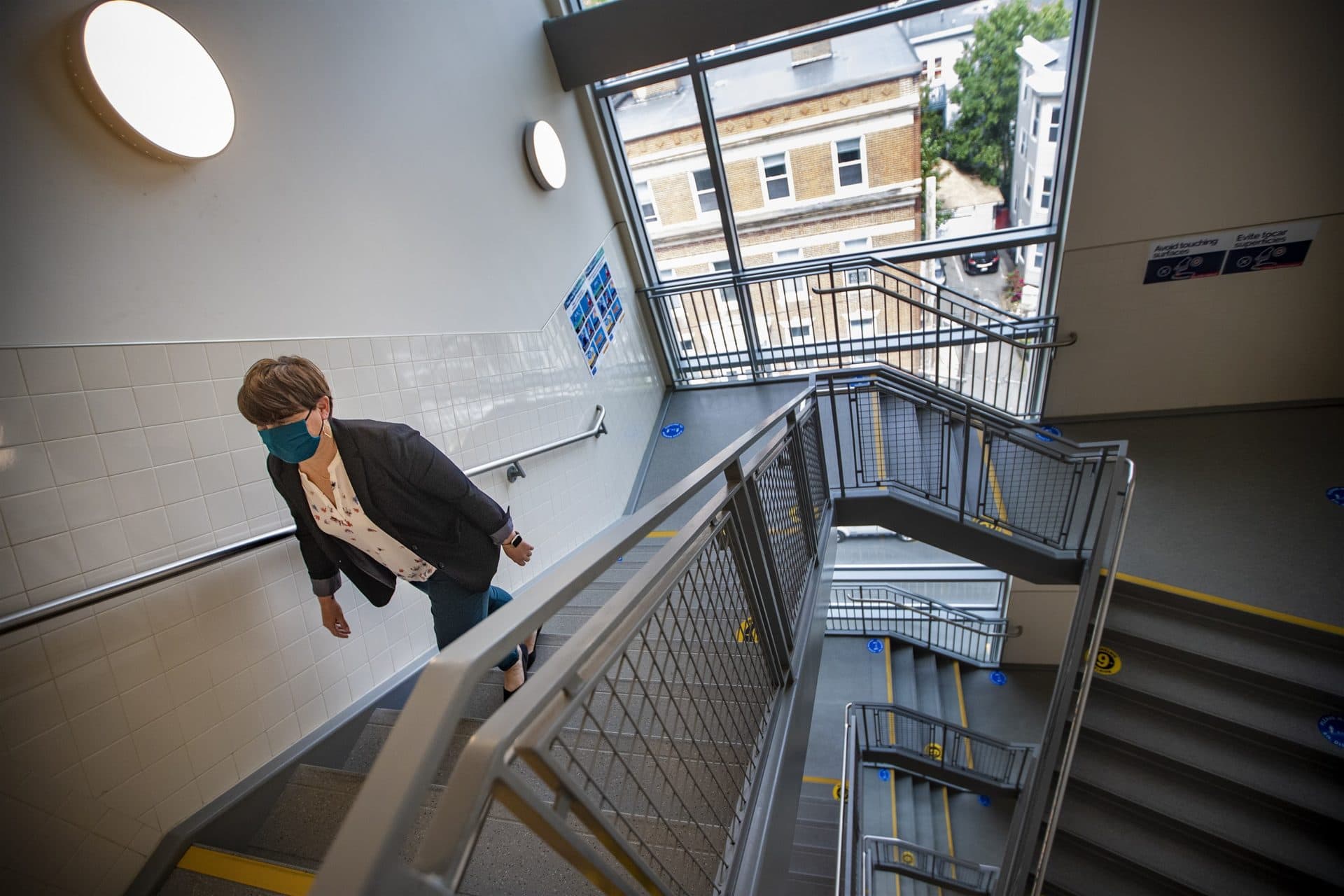 Kim Huffer, Chelsea Public Schools' coordinator of social work services, walks up a stairway inside the Clark Avenue Middle School. (Jesse Costa/WBUR)