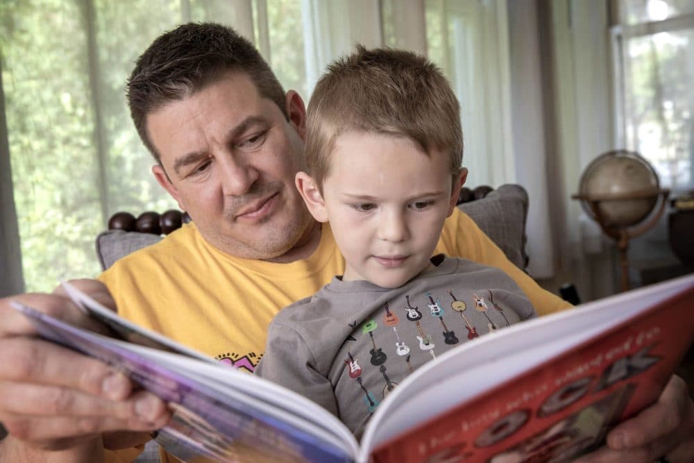 David Weiser reads "The Boy Who Wanted to Rock" with his son Arlen, who is featured in the book. (Robin Lubbock/WBUR)
